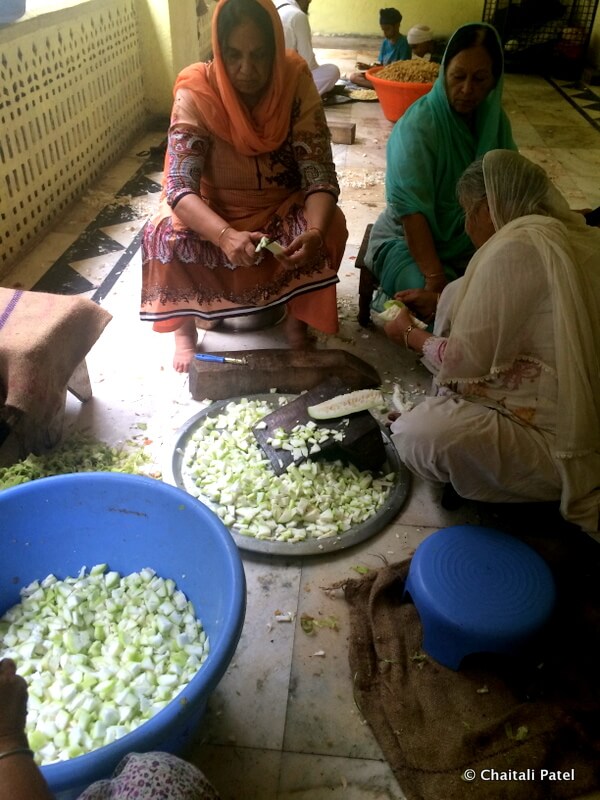 People chopping vegetables as part of langar seva